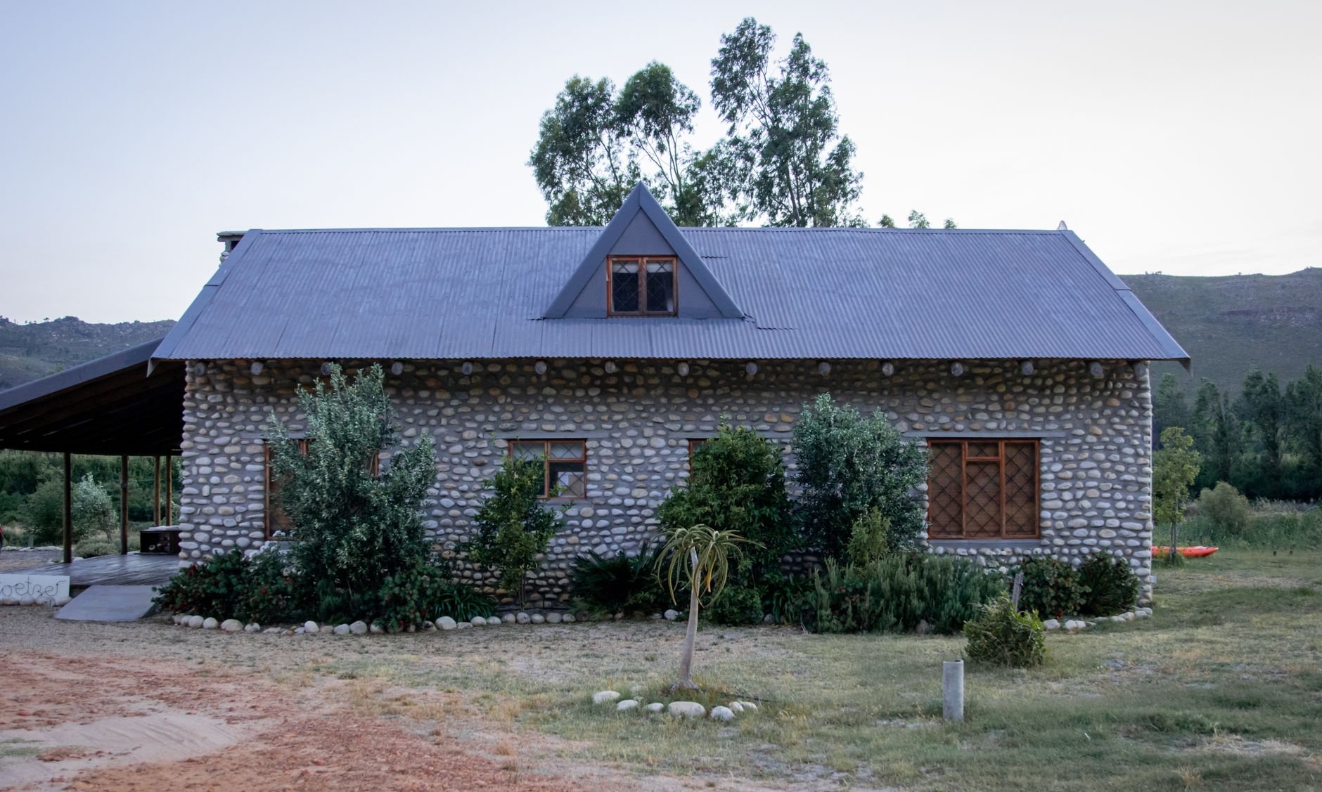 Charming rustic stone farmhouse with lush garden in serene countryside setting