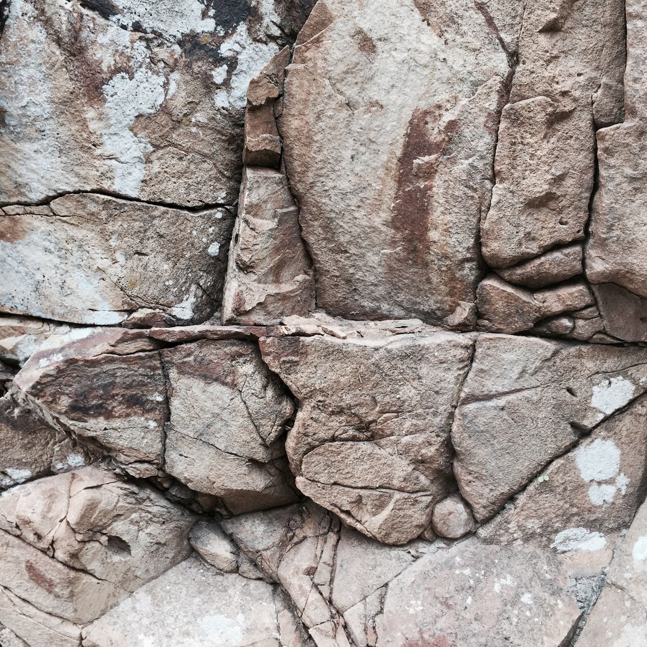 Detailed close-up of natural stone wall texture with deep character